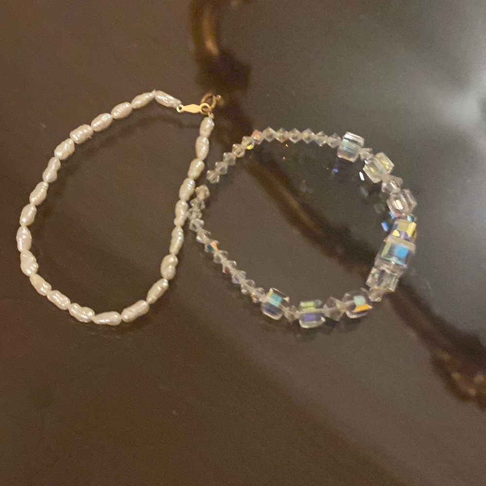 2 bracelets. One is fresh water pearl and the other is Crystal